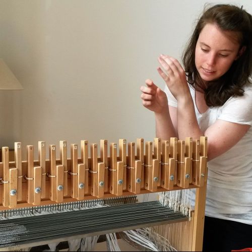 Charlotte Simonis avec son métier à tisser à 24 cadres